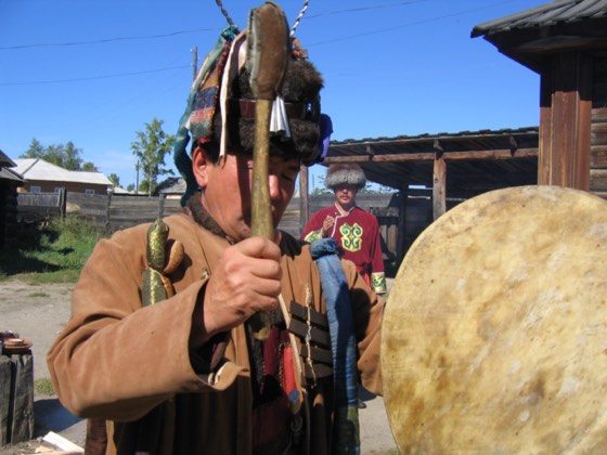 A shaman performing a rite with a drum